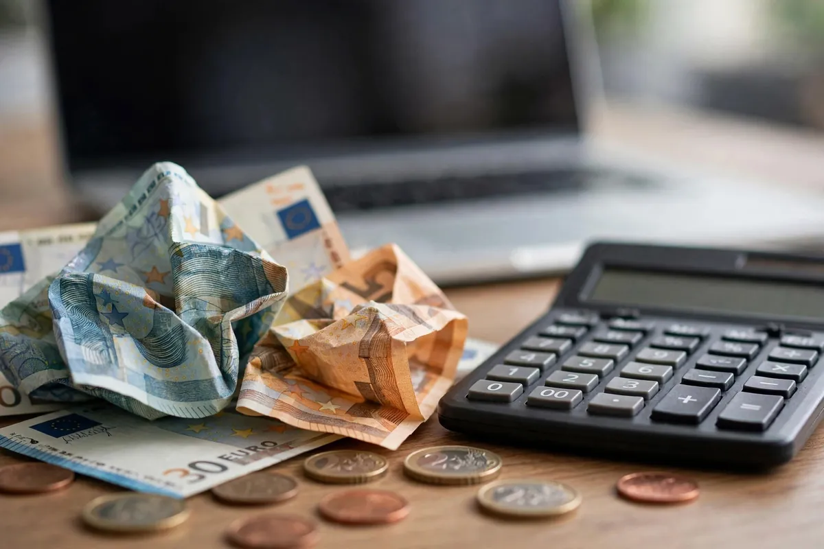 convert BNP Paribas statement PDF to Excel — euro banknotes and calculator beside a desk