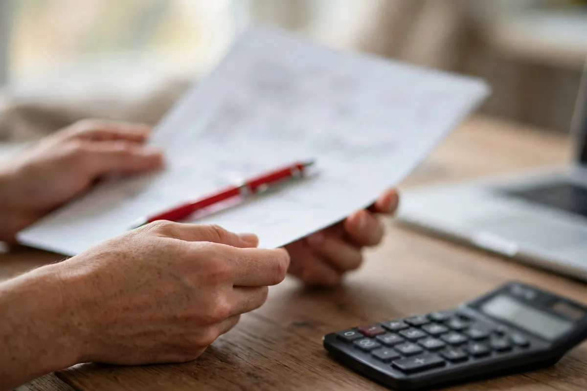 stripe quickbooks integration review — bookkeeper checking a printed payout report beside a laptop